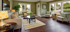 Well decorated living room with hardwood floor, and green yellow theme.